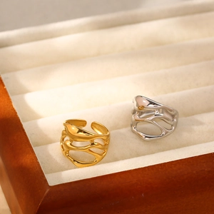 Detail of artistic gold and silver irregular hollow rings in a velvet jewelry box