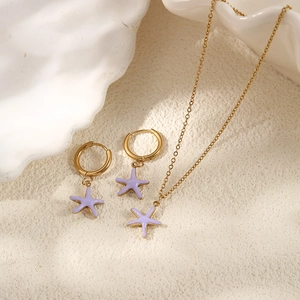 Close-up of lavender starfish earrings and necklace set in gold stainless steel