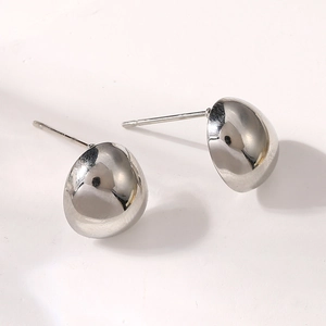 Macro detail of polished silver teardrop stud earrings with smooth mirror finish