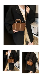 Close-up of retro brown suede handbag with leather handles and adjustable shoulder strap