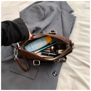 Internal view of the brown suede handbag showing spacious storage for cosmetics