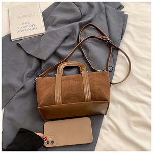 Brown Boston bag shown next to a smartphone to demonstrate the practical compact size