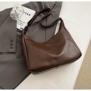 Detail of dark brown vintage PU leather hobo bag with adjustable wide shoulder strap