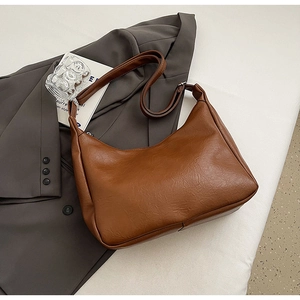 Close-up of caramel brown tote bag with premium lychee grain faux leather texture