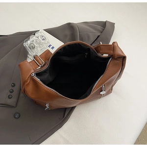 Internal view of large brown vintage tote bag showing black lining and zip pocket