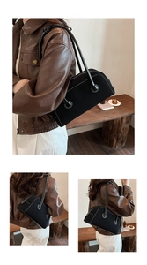 Detail view of black canvas Boston bag with leather straps and contrast stitching
