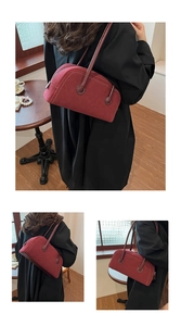 Macro shot of burgundy suede Boston bag showing soft texture and premium top zipper detail