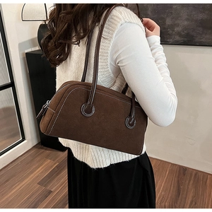 Brown faux suede Boston bag with white stitching detail, shown in a casual side view style