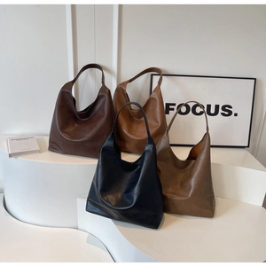 Minimalist faux leather tote bags displayed in dark brown, caramel, black, and olive green