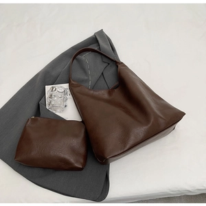 Detailed view of dark brown PU leather tote set with crossbody bag and textured finish