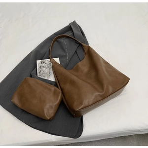 Close-up of minimalist brown PU leather tote bag with a matching small inner pouch