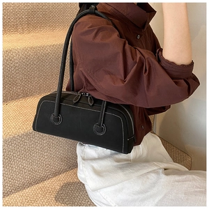 Detail of black tote bag featuring white contrast stitching and double zipper closure