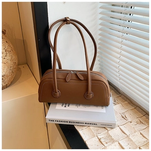 Close-up of brown vintage tote bag with smooth synthetic leather and fine stitching detail