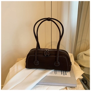 Detailed view of dark brown tote bag with white contrast stitching and double zippers