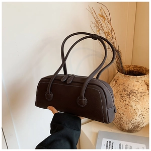 Detail shot of vintage dark brown tote bag featuring fine white contrast stitching and zip