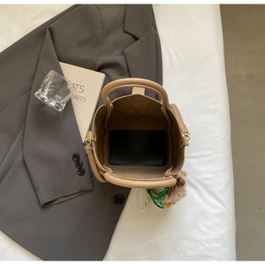 Top view of khaki bucket bag showing spacious interior with litchi grain leather texture
