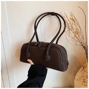 Detail of dark brown leather tote bag with white contrast stitching and double zippers