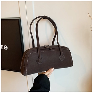Detail view of brown vintage tote bag showing white contrast stitching and matte texture