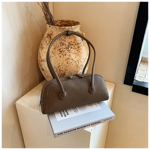 Detail view of vintage tote bag featuring contrast white stitching and long shoulder straps