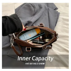 Frosted brown suede satchel bag with interior view showing large cosmetic storage capacity