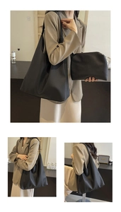Close-up of a black textured leather hobo bag with a matching small zipper pouch set