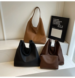 Detailed set of large leather tote bags in brown and black with matching pouches