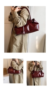 Dettaglio di una borsa tote bordeaux lucida con grande capacità e manico a spalla