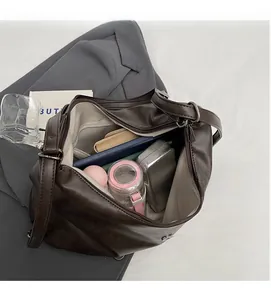 Spacious interior of dark brown retro shoulder bag with multiple personal essentials