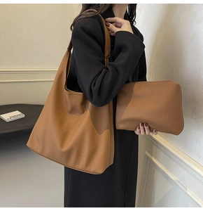 Detail of caramel brown tote bag set with matching pouch and premium pebble texture