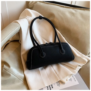 Detail of black suede tote bag with white contrast stitching and metallic zipper