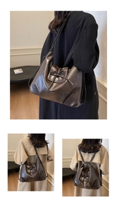 Detail showing vintage dark coffee leather backpack with bow-knot and magnetic clasp
