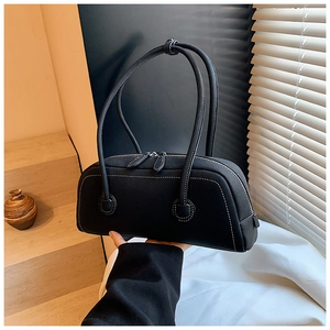 Detail of black Boston tote bag featuring white contrast stitching and double zipper closure