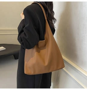 Brown tote bag with lychee texture shown on model for daily commuting style
