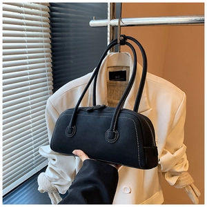 Detail of matte black tote bag with white contrast stitching and long shoulder handles