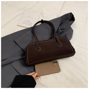 Detail view of large brown suede tote bag with contrast stitching and size reference