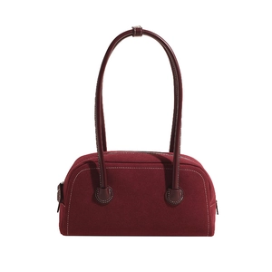 Chic burgundy suede Boston bag with white contrast stitching and matching leather handles