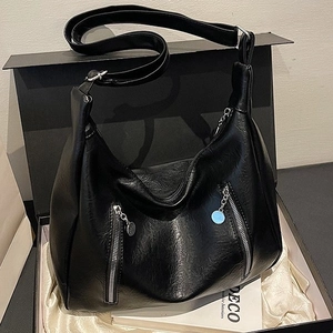 Retro black faux leather large tote bag with decorative metal zippers in a luxury gift box