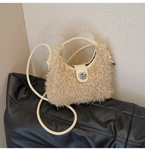 Detail of plush faux fur handbag featuring cream leather straps and silver twist lock