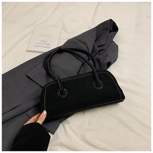 Detail of black tote bag with white contrast stitching and matte vintage finish