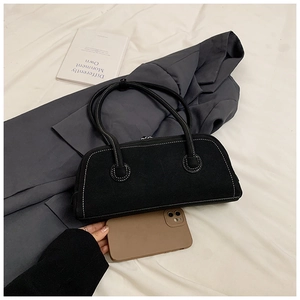 Detail of vintage black tote bag with white contrast stitching and long handles