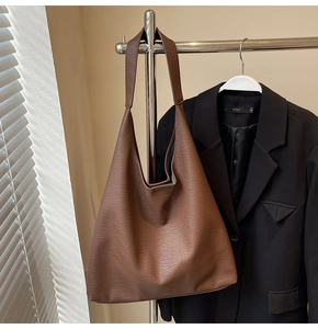 Close-up of caramel brown hobo tote bag featuring premium pebbled leather texture