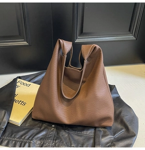 Detail of large brown tote bag with premium lychee texture on soft faux leather