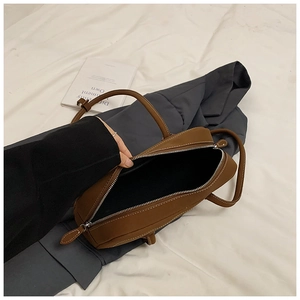 Detail view of large brown retro tote bag showing contrast stitching and spacious interior