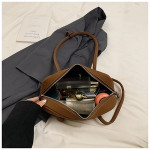 Internal view showing large capacity of the brown leather tote bag with various personal items