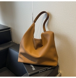 Close-up of the rich lychee texture leather on this large brown hobo tote shoulder bag
