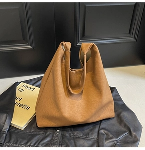 Detail of caramel brown hobo bag showing high-quality pebbled leather texture