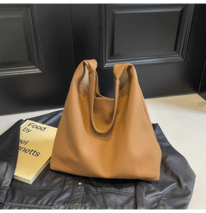 Detail of tan faux leather texture on a large minimalist commuter tote bag