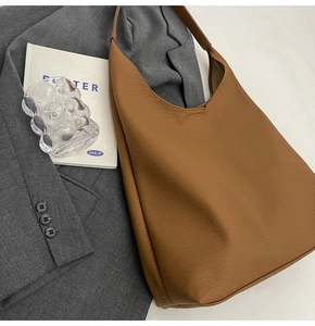 Close-up of the pebbled leather texture on a brown large-capacity tote bag for women