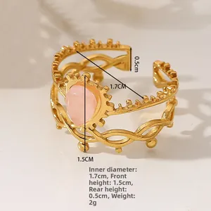 Detail view of adjustable gold-plated ring featuring pink pear gemstone and sizing specs