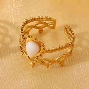 Detail of 18k gold plated stainless steel layered ring with white teardrop gemstone